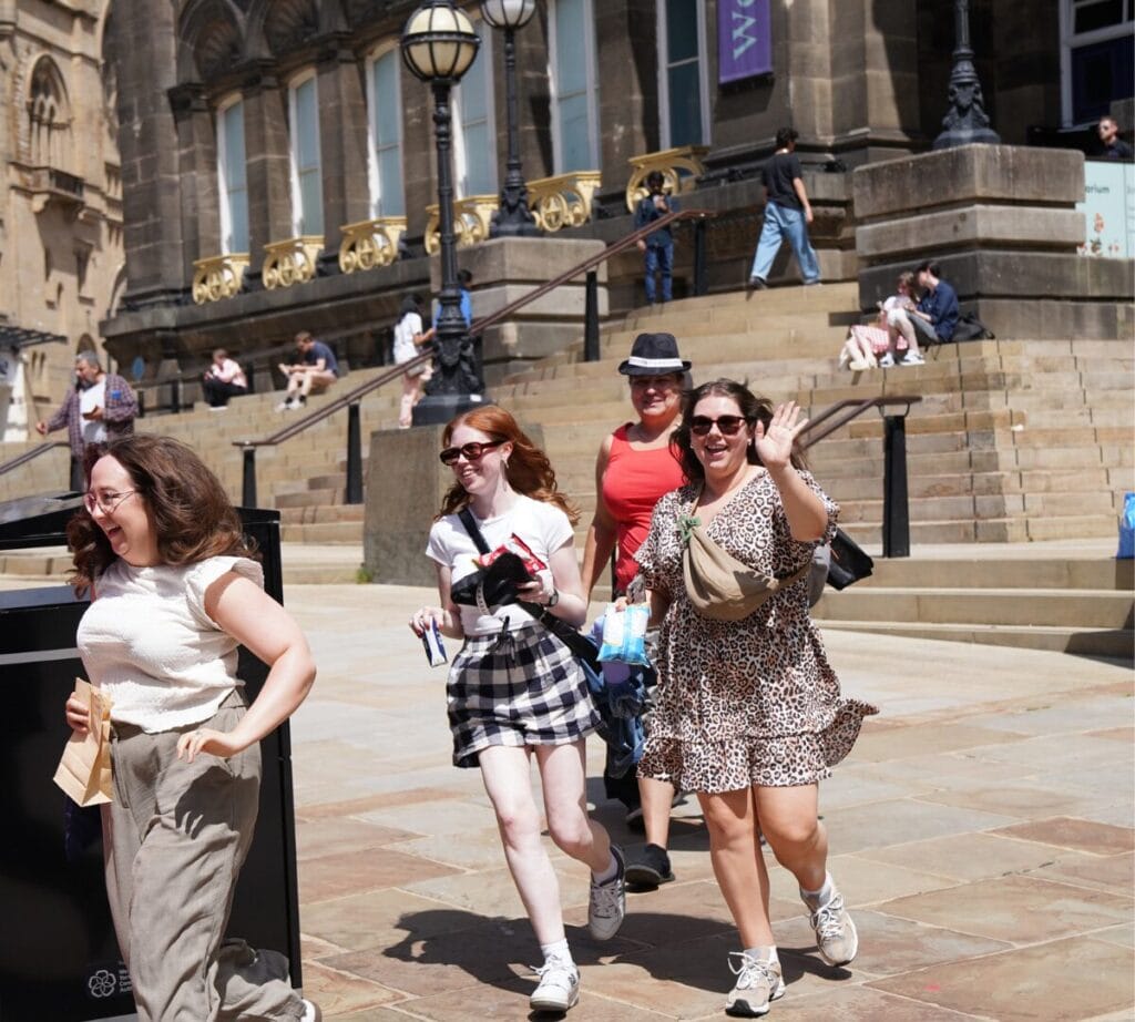 A team of 4 women are running down the steps 