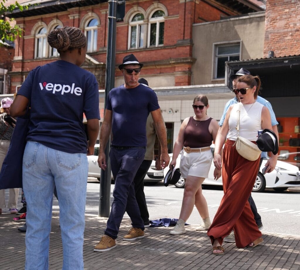 Teams completing a box step challenge, all doing a synchronized dance move with a Vepple team member leading.