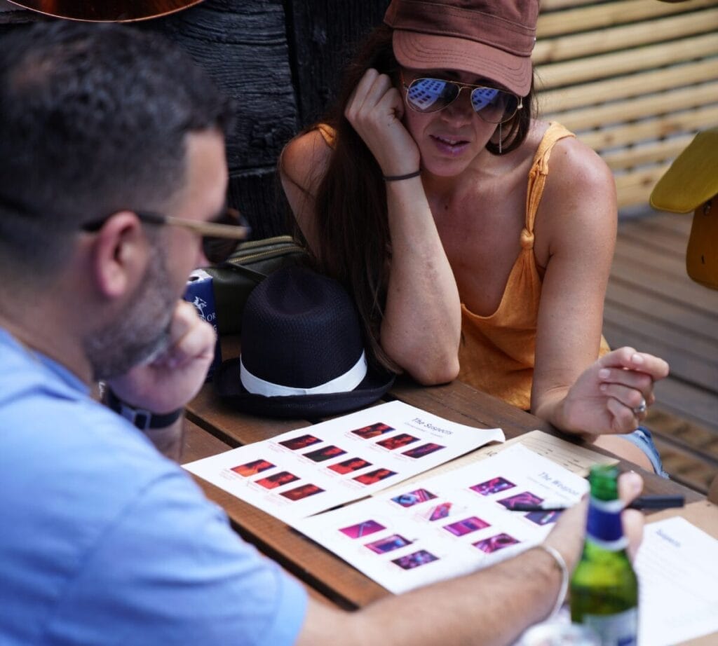 Two players are looking at the case file with confused looks on their face.