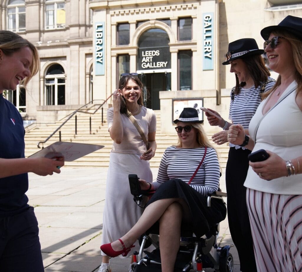 4 players stand outside the Leeds Art Gallery with a Vepple staff member completing a challenge.