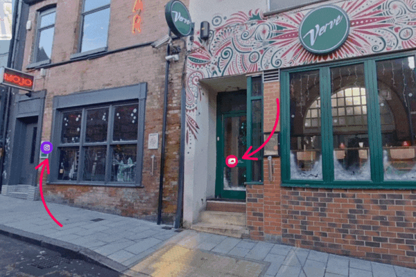 Street view of Verve bar with green door; arrows mark an entry system and security cameras, with a MOJO sign on the left.