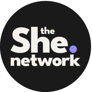 Logo reading the She. network in bold white letters on a black circle, with the dot after She in purple.